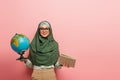 joyful muslim teacher with globe and