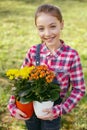 Joyful nice girl being interested in flowers