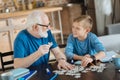 Joyful nice man collecting jigsaw puzzles