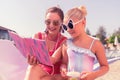 Joyful nice mother and daughter reading a book together