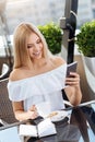 Joyful nice woman holding her smartphone Royalty Free Stock Photo