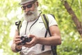 Joyful old man using camera during his journey Royalty Free Stock Photo