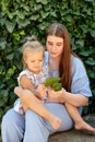 Joyful older sister holding younger sister, playing and laughing, having fun. Teen girl holding baby girl on summer day Royalty Free Stock Photo