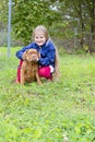 Joyful photo of a child and a puppy. Dogue de Bordeaux puppy and his little mistress. A child and a puppy are smiling on