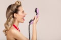 Joyful pin-up girl shout on retro phone Royalty Free Stock Photo