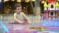 Joyful playful boy playing air hockey on the playground. Entertainment for children Royalty Free Stock Photo