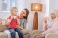 Joyful pleasant family having tea