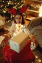 Joyful pleased x-mas woman receiving present boxes with first person view Royalty Free Stock Photo