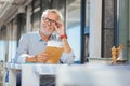 Joyful positive aged man fixing his glasses