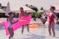 Joyful positive girl using a water gun