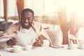 Joyful positive man adding sugar to his tea Royalty Free Stock Photo