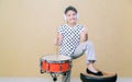 joyful pretty little girl standing and holding sticks behind a snare drum