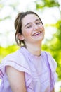 Joyful Radiance: A Woman's Beaming Smile in Sunlit Surroundings