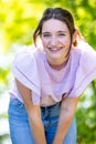 Joyful Radiance: Young Brunette Embracing Happiness in Sunlit Forest