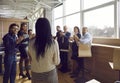 Joyful satisfied business people applauding their female colleague at team meeting in office. Royalty Free Stock Photo