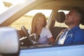 Joyful scene of young couple and dog during road trip