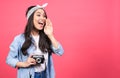 Joyful screaming asian girl taking pictures on retro vintage camera Royalty Free Stock Photo