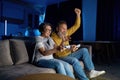 Joyful senior couple playing video games together at home Royalty Free Stock Photo