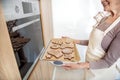 Joyful senior lady baking Christmas cookies in kitchen Royalty Free Stock Photo