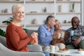 Joyful senior lady knitting, sitting by her multiracial friends Royalty Free Stock Photo