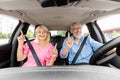 Joyful senior man and woman riding auto, singing songs Royalty Free Stock Photo
