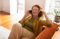Joyful senior woman laughing while talking on smartphone at home Royalty Free Stock Photo