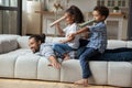 Happy little African American kids playing with father.