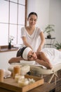 Joyful skillful woman doing body massage