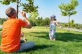 Joyful small daughter is playing with father on a green meadow Royalty Free Stock Photo