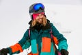 joyful smiling man skier in bright colorful ski suit against background of snow Royalty Free Stock Photo