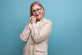 joyful smiling 50s mature woman smiling on plain background with copy space Royalty Free Stock Photo