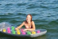 Joyful smiling teenage girl bathes with air mattress in the sea Royalty Free Stock Photo