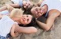 family lying on beach, top view. Royalty Free Stock Photo