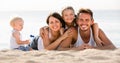 Parents with two kids lying on the beach Royalty Free Stock Photo