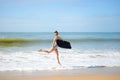 Joyful surfer girl happy cheerful running surfing at ocean beach water. Female bikini heading for waves with surfboard Royalty Free Stock Photo