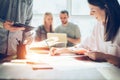 Joyful team brainstorming. New marketing plan researching. Paperwork on the table, laptop and mobile phone Royalty Free Stock Photo