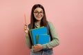 Joyful teen student with backpack and workbooks has a bright idea Royalty Free Stock Photo