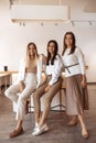 Joyful three young women friends having fun at the cafe indoors. Royalty Free Stock Photo