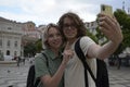 Joyful tourist couple taking selfie