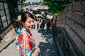 Joyful tourist with kimono visiting Sannen street