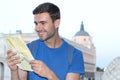 Joyful tourist reading map with copy space Royalty Free Stock Photo