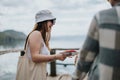 Joyful tourists enjoying a trip at a lakeside location, woman laughing with travel companion