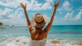 Joyful traveling woman leaps with hands up on the beach, viewed from behind.