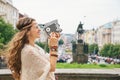 Joyful trendy hippie woman tourist with retro camera in Prague Royalty Free Stock Photo