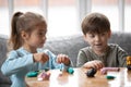 Joyful two cute little preschool children playing with playdough. Royalty Free Stock Photo