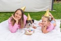 Joyful two girls sisters celebrating their dog\'s birthday