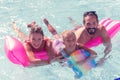 Joyful united family swimming together on the air bed Royalty Free Stock Photo