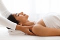 Joyful woman getting relaxing body shoulders massage at wellness center Royalty Free Stock Photo