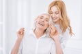 Joyful woman and her adult daughter resting at home together Royalty Free Stock Photo