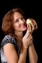 Joyful woman holding fresh apple. Photo session in the studio Royalty Free Stock Photo